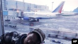 A man sleeps at Moscow's Domodedovo airport on Sunday, Dec. 26, 2010.