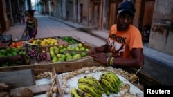 Self-employed Yuqui Morales sells produce from a cart in Havana, Cuba, April 14, 2018. 