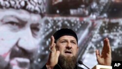 Chechnya's regional leader Ramzan Kadyrov speaks in front of a portrait of his father Akhmad Kadyrov, the Chechen president who was assassinated in a 2004 bomb blast, during a meeting in Grozny, Russia. (File) 