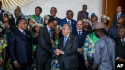 United Nations Secretary-General Antonio Guterres, center right, shakes the hand of Rwandan President Paul Kagame during the 28th Ordinary Session of the Assembly of the African Union, in Addis Ababa, Ethiopia, Jan. 30, 2017. 