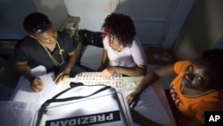 Electoral workers count ballots during their country's general elections, in Port-au-Prince, Haiti, Oct. 25, 2015. 