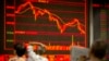 Chinese investors monitor stock prices at a brokerage house in Beijing, July 6, 2018.