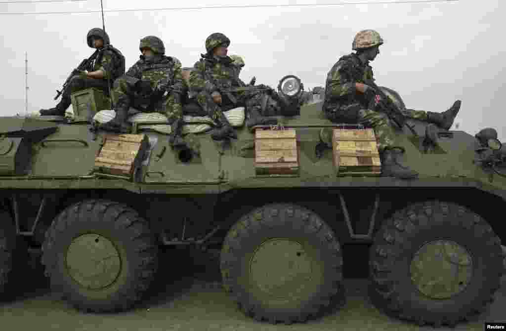 Ukrainian soldiers sit on an armored personnel carrier at a Ukrainian checkpoint, Slovyansk, May 2, 2014.