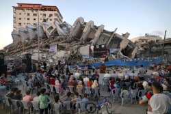 Palestinian musicians perform on the rubble