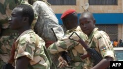 Soldiers patrol on an armoured vehicle as people demonstrate for the restoration of peace within the country in Bangui, Sept. 2, 2013.