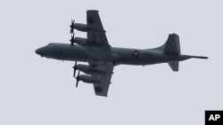 A U.S. P3 Orion surveillance plane flies over Marawi city, southern Philippines as Philippine Air Force helicopters and bombers continue air strikes, June 9, 2017.