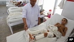 Afghan child war victims receive treatment at the Emergency Hospital in Kabul, Afghanistan, July 25, 2016. The United Nations mission in Afghanistan says the number of children killed or wounded in the country's conflict has surged in the first half of th