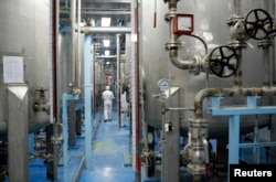 FILE - A technician is seen at the uranium conversion facility in Isfahan, 450 kilometers south of Tehran, Feb. 3, 2007.