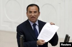 FILE - Justice Minister Bekir Bozdag addresses the Turkish Parliament during a debate in Ankara, March 19, 2014.