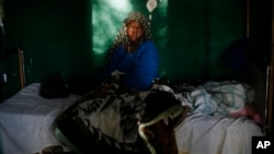 FILE - A teenage malaria patient sits in a bed at a hospital in Gao, northern Mali, Feb. 11, 2013.