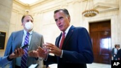 FILE - Sen. Mitt Romney, R-Utah, talks briefly to reporters after attending a bipartisan barbecue luncheon, at the Capitol in Washington, Sept. 23, 2021.