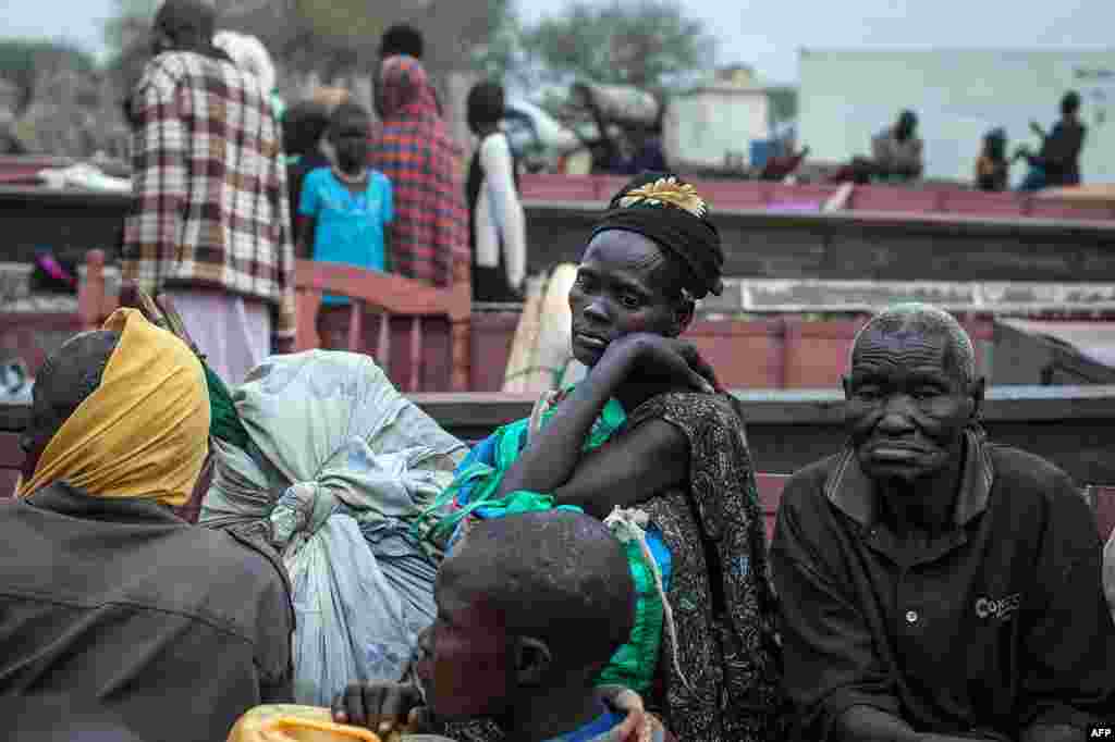 People unload the few belongings on Jan. 9, 2014 at Minkammen, South Sudan, that they were able to bring with them to camps for the displaced.