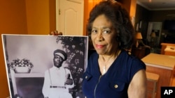 Josephine Bolling McCall poses with a photo of her father, lynching victim Elmore Bolling, at her home in Montgomery, Alabama, April 18, 2018. Bolling is among thousands of lynching victims remembered at the new National Memorial for Peace and Justice, erected with donations by the Alabama-based Equal Justice Initiative. The memorial and an accompanying museum, which aim to tell the story of racial oppression in the United States, open April 26.