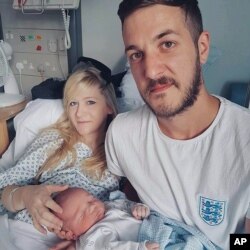 This is an undated hand out photo of Chris Gard and Connie Yates with their son Charlie Gard provided by the family, at Great Ormond Street Hospital, in London.