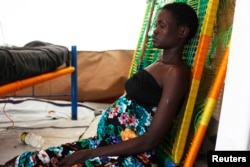 A pregnant woman sits on the floor at a hospital in Minakaman, Lakes State, South Sudan, June 26, 2014.