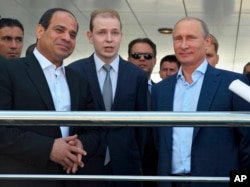 Russian President Vladimir Putin, right, and Egyptian President Abdel-Fattah el-Sissi, second left, listen to a translator during a meeting in the Russian Black Sea resort of Sochi, Russia, Aug. 12, 2014.