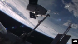 In this frame from NASA TV, the SpaceX Dragon capsule arrives at the International Space Station bearing supplies on July 20, 2016. 