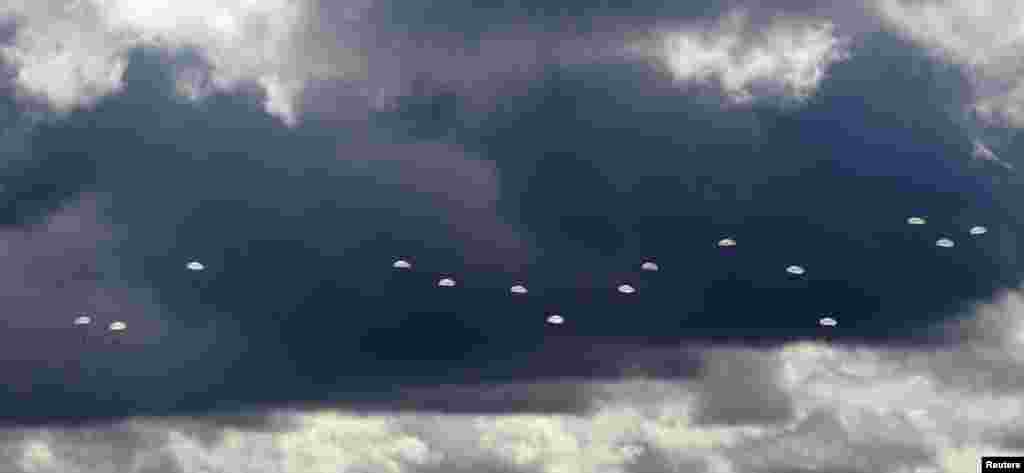 Military parachutists above a military base near the town of Osipovichi, some 100 km (62 miles) southeast of Minsk, Belarus.