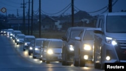 A traffic jam is seen as people evacuate after tsunami advisories were issued following an earthquake, in Iwaki, Fukushima prefecture, Japan, in this photo taken by Kyodo, Nov. 22, 2016.