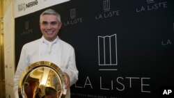  French Swiss Chef Benoit Violier of the restaurant Hotel de Ville in Crissier, Switzerland, poses with his trophy for the best restaurant of the World during the award ceremony of "La Liste" (The List) at the French Foreign Ministry in Paris. Swiss police say Monday, Feb.1, 2016 that 3-star chef Benoit Violier, whose restaurant near Lausanne recently topped a list of the world's best, has been found dead of an apparent self-inflicted gunshot. 