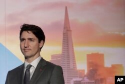 Canada's Prime Minister Justin Trudeau waits to speak at the AppDirect office in San Francisco, Feb. 8, 2018.