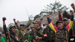 Members of community based anti-narcotic campaigners known as The Pat Jasan shout slogans protesting against the government’s ban prohibiting the group from destroying poppy farms in Wai Maw, northern Kachin State, Myanmar, Feb. 21, 2016.