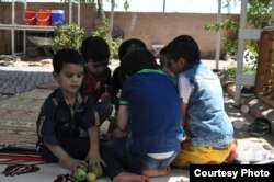 Children eat fruit at the Selam Orphanage. (M. Qarra)