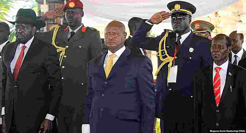 South Sudanese President Salva Kiir (left), Ugandan President Yoweri Museveni (C.) and South Sudan Vice President James Wani Igga (right) stand to attention as South Sudan marks its 4th anniversary of independence on Thursday, July 9, 2015. 