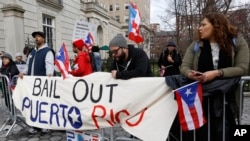 FIL E - Protesters express their opposition to the fact the the Federal Reserve bank bailed out Wall Street but not Puerto Rico outside International House, in New York, April 7, 2016.