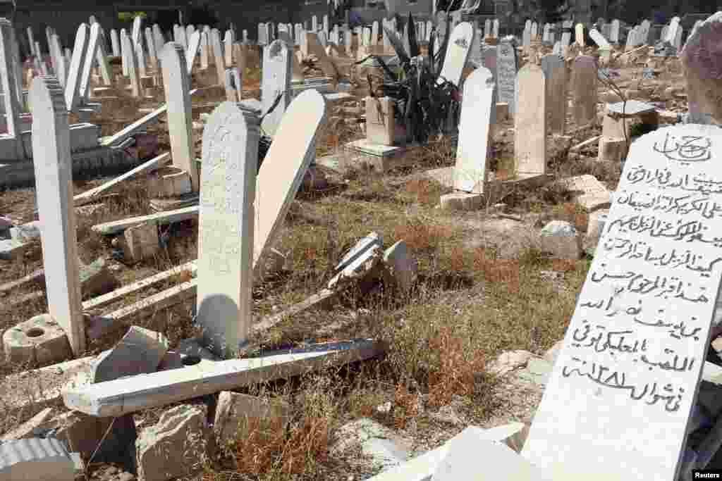 Damaged graves are pictured at a cemetery in Duma neighborhood in Damascus, Oct. 1, 2013. 