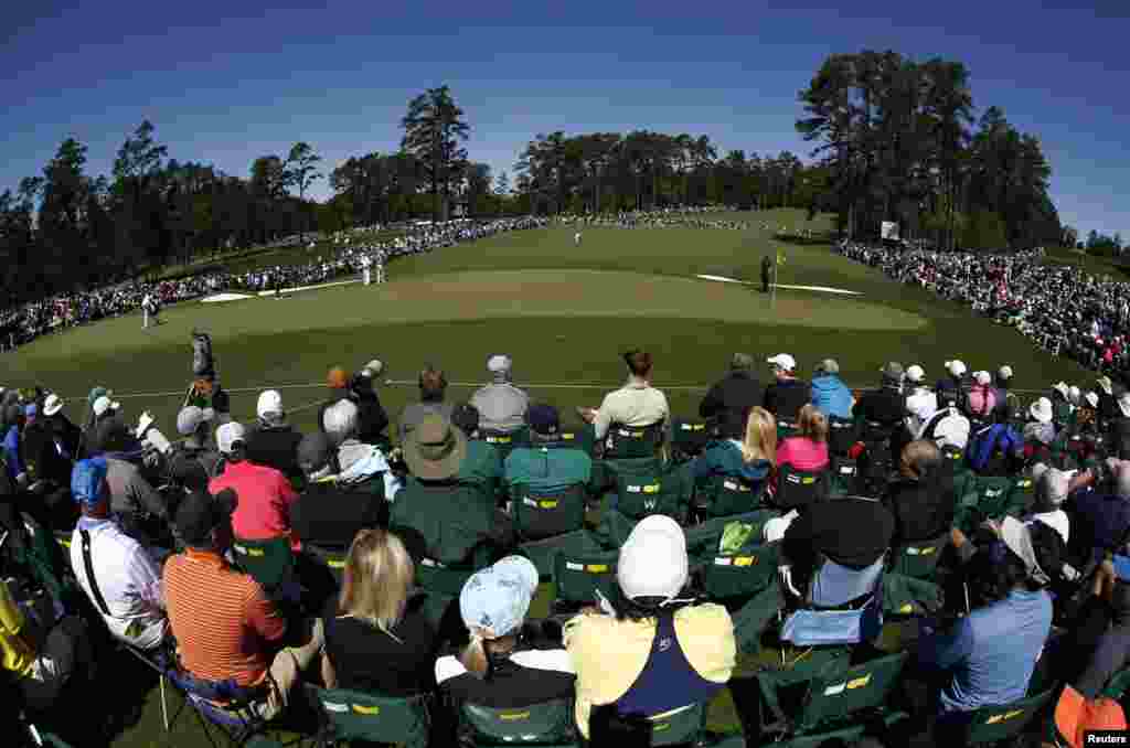 Martin Kaymer, Bill Haas and Rory McIlroy are seen on the 2nd green during the second round of the 2016 Masters golf tournament at Augusta National Golf Club, Augusta, Georgia. (Rob Schumacher-USA TODAY Sports)
