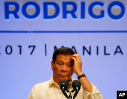 FILE - Philippines President Rodrigo Duterte gestures while addressing the media following the conclusion of the 30th ASEAN Leaders' Summit in Manila, Philippines, April 29, 2017.
