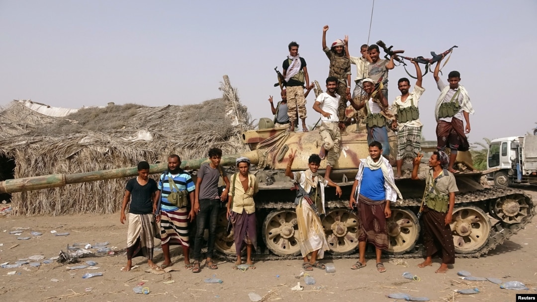 Tribal fighters loyal to the Yemeni government stand by a tank in al-Faza area near Hodeida, Yemen, June 1, 2018.