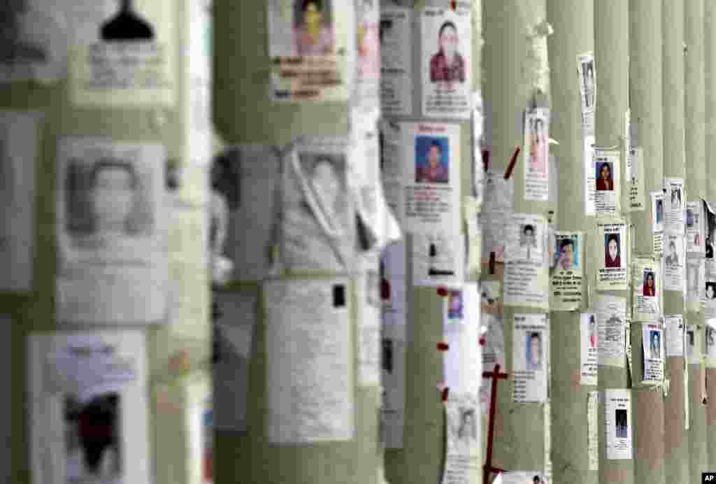 A school turned make-shift morgue has its walls plastered with portraits of missing persons, mostly workers at the garment factory building which collapsed, plastered over its walls on April 29, 2013 in Savar, near Dhaka, Bangladesh. 