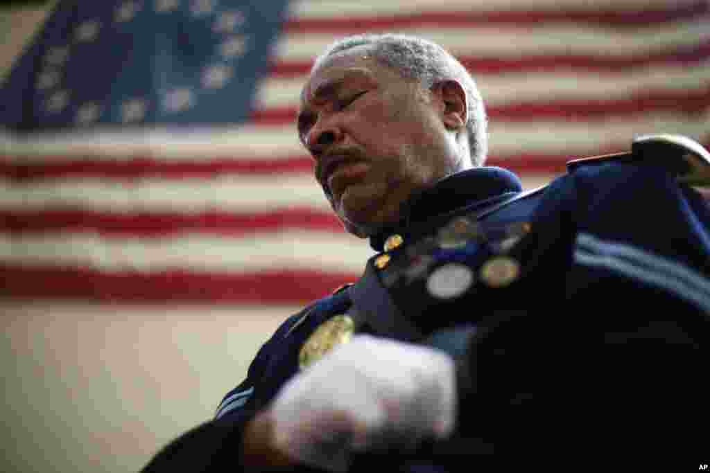 Civil War re-enactor Cpl. Robert Fuller Houston with the 3rd Regiment Infantry, lowers his head during a prayer at a ceremony, Sept. 11, 2013, marking the 12th anniversary of the 9/11 terrorist attacks at the Betsy Ross House in Philadelphia.