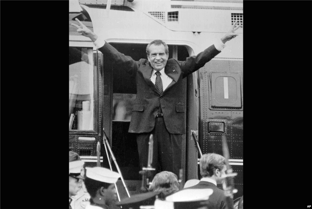 Richard Nixon says goodbye to members of his staff outside the White House in Washington as he boards a helicopter for Andrews Air Force Base after resigning the presidency in Washington, D.C., August 9, 1974. (AP Photo)