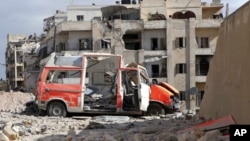 In this photo provided by the Syrian Civil Defense group known as the "White Helmets," a destroyed ambulance is seen in the Ansari neighborhood in the rebel-held part of eastern Aleppo, Syria, Sept. 23, 2016.