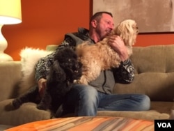 Bobby's dogs scamper into his lap at his home in Kansas. The Affordable Care Act pays for expensive prescriptions that keep Bobby alive. He agrees the law isn't perfect but hopes Congress doesn't eliminate it. (C. Presutti/VOA)
