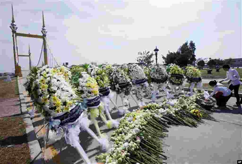 Cambodia University students lay down flowers during a memorial service near a bridge where festival goers were killed Monday in a stampede in Phnom Penh, Cambodia, Thursday, Nov. 25, 2010. (AP Photo/Sakchai Lalit)