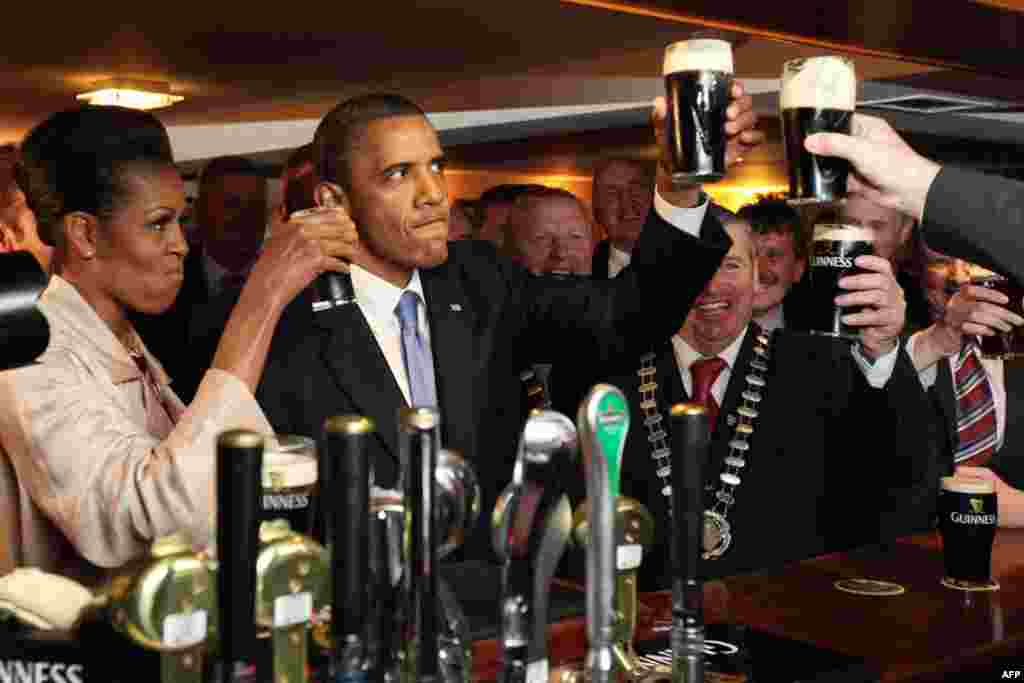 May 23: President Barack Obama and first lady Michelle Obama drink Guinness beer as they meet with local residents at Ollie Hayes pub in Moneygall, Ireland, the ancestral homeland of his great-great-great grandfather. (AP Photo/Pool)
