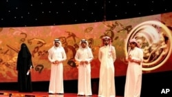 Saudi poet Hissa Hilal (L) stands next to the other contestants during the final episode of the talent show 'Million's Poet' in Abu Dhabi late on 07 Apr 2010