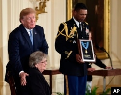 President Donald Trump speaks before he awards the Medal of Honor to 1st Lt. Garlin Conner as his widow Pauline Connor accepts the posthumous recognition, during a ceremony in the East Room of the White House in Washington, June 26, 2018.