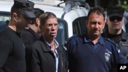 EgyptAir plane hijacking suspect Seif Eddin Mustafa, second left, is escorted by Cyprus police officers as he leaves a court after a remand hearing as authorities investigate him on charges including hijacking, illegal possession of explosives and abduction in the Cypriot coastal town of Larnaca Wednesday, March 30, 2016. Mustafa described as "psychologically unstable" hijacked a flight Tuesday from Egypt to Cyprus and threatened to blow it up. His explosives turned out to be fake, and he surrendered with all passengers released unharmed after a bizarre six-hour standoff.