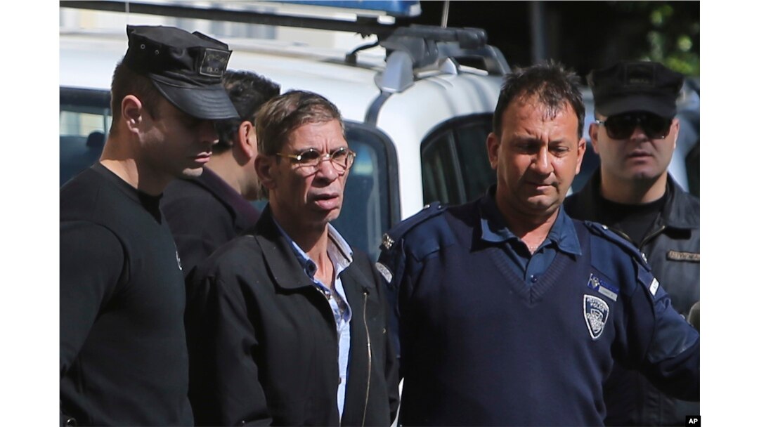 EgyptAir plane hijacking suspect Seif Eddin Mustafa, second left, is escorted by Cyprus police officers as he leaves a court after a remand hearing as authorities investigate him on charges including hijacking, illegal possession of explosives and abduction in the Cypriot coastal town of Larnaca Wednesday, March 30, 2016.