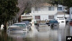 Submerged automobiles are shown on flooded Nordale Avenue in San Jose, California, Feb. 22, 2017.