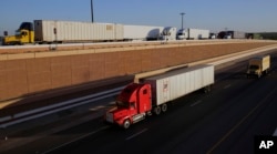 Trucks move along Interstate 35, in Laredo, Texas, Nov. 21, 2016. Donald Trump’s campaign promise to abandon the North American Free Trade Agreement helped win over Rust Belt voters who felt left behind by globalization. But the idea is unnerving to many people in cities on the U.S.-Mexico border.
