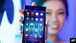 A Blackberry Z3 smartphone is shown by a model during its launch in Jakarta, Indonesia, May 13, 2014. The Z3 is priced at (US $200) in the country. 