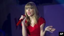 Taylor Swift performs songs from her newly released album 'Red' onstage at a shopping center after switching on the Christmas lights, London, Nov. 6, 2012.