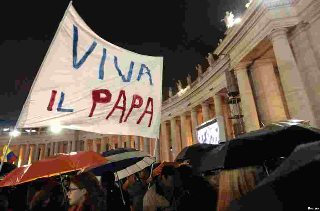 Crowds cheer as white smoke rises from the chimney above the Sistine Chapel, March 13, 2013. 