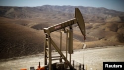 FILE - A pumpjack brings oil to the surface in the Monterey Shale, California, April 2013.
